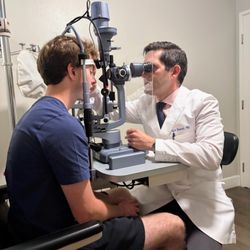 Dr. Igor Bussel performing a slit lamp examination in the clinic.