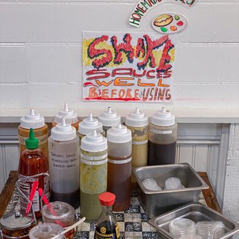 Nhà Mình - a variety of condiments on a table - Sandwiches Near Me - Ridgewood, New York