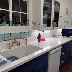 Denton's Custom Woodworks - New slab countertop and cabinets. This kitchen gets serious cooking workouts and stays very nice after a good cleaning.