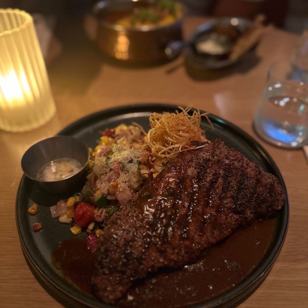 Earls Kitchen + Bar - a steak on a black plate - Canadian (New) Near Me - North York, Ontario Earls Kitchen + Bar - a steak on a black plate - Canadian (New) Near Me - North York, Ontario