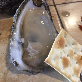Clermont Oyster Bar - Oysters shucked at the bar! The cracker shows the size of one of the oysters. - Seafood Near Me - Clermont, Florida Clermont Oyster Bar - Oysters shucked at the bar! The cracker shows the size of one of the oysters. - Seafood Near Me - Clermont, Florida
