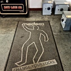 F M George Safe And Lock Company - Safes, and rug with crime chalk outline - Change Your Locks. It's Not Worth the Risk. F.M. George & Safe Lock Co.