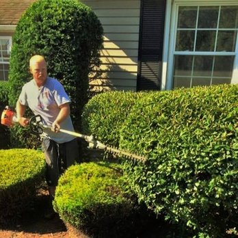 NRI Landscaping - a man trimming bushes - Landscaping Near Me - Cumberland, Rhode Island NRI Landscaping - a man trimming bushes - Landscaping Near Me - Cumberland, Rhode Island