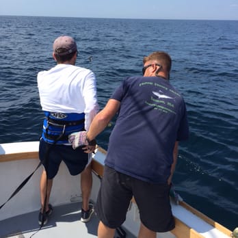 Fishing Frenzy Charters - Captain Scott coaching Will on proper technique - Fishing Near Me - Boston, Massachusetts
