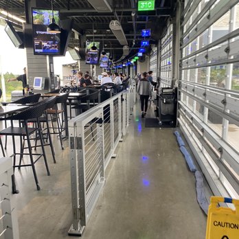 Topgolf - Hallway with tons of bays - New American Near Me - Orlando, Florida Topgolf - Hallway with tons of bays - New American Near Me - Orlando, Florida
