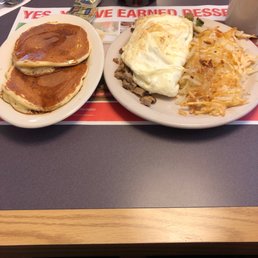 Egg White Omelette with mushrooms, onions, green peppers, cheese, and diced turkey sausage.  Side of pancakes and coffee.