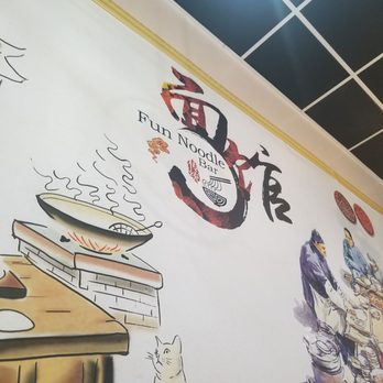 Fun Noodle Bar - Decorative wall art at Fun Noodle Bar includes the logo and illustrations of a steaming noodle bowl and chefs preparing food. - Chinese Near Me - Santa Fe, New Mexico