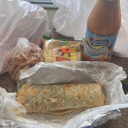 Vegetable roti, mithai, curry powder, and hot sauce. Vegetable roti, mithai, curry powder, and hot sauce.