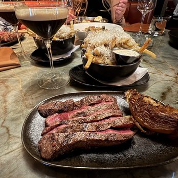 Braven - Flatiron steak (rare), roasted onion and truffle fries. - Steakhouses Near Me - Edmonton, Alberta Braven - Flatiron steak (rare), roasted onion and truffle fries. - Steakhouses Near Me - Edmonton, Alberta
