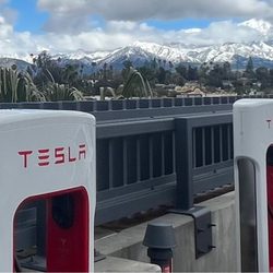 Tesla Supercharger - Rooftop chargers and the beautiful mountains covered in snow