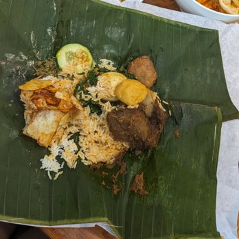 Sumatera Restaurant NYC - Nasi bungkus - rice, beef rendang, sambal potato chips, sambal anchovy, cucumber, boiled egg, tofu puff, potato, jackfruit - Indonesian Near Me - Elmhurst, New York