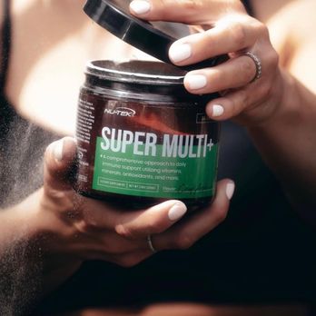 Nutrishop - a woman holding a jar of super multi - Health Markets Near Me - Maple Grove, Minnesota