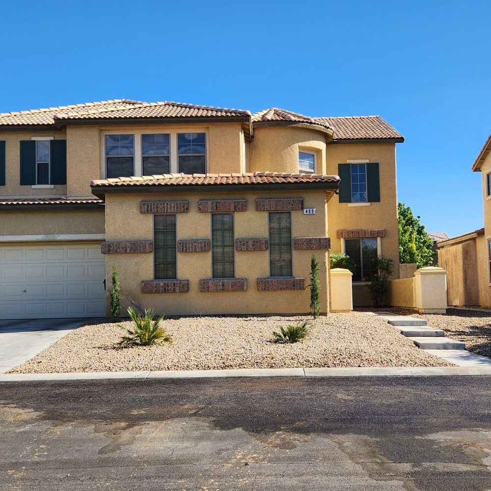 AAA Landscaping - After. Replenished rocks, cypress trees balanced on either side. Very clean looking. - Landscaping Near Me - Henderson, Nevada