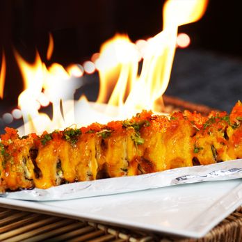 Sushi Komi - a close up of a plate of food with flames in the background - Sushi Bars Near Me - Salem, Oregon Sushi Komi - a close up of a plate of food with flames in the background - Sushi Bars Near Me - Salem, Oregon