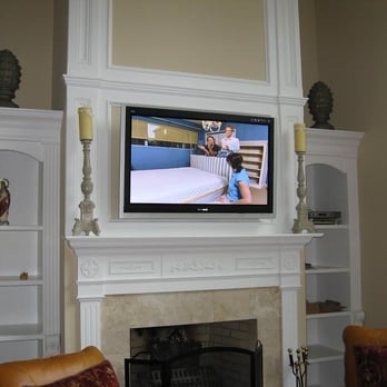 Dynamic Audio & Video - This great room TV was mounted above a wood burning fireplace. All source components are on shelves to the right. - Home Theatre Installation Near Me Dynamic Audio & Video - This great room TV was mounted above a wood burning fireplace. All source components are on shelves to the right. - Home Theatre Installation Near Me