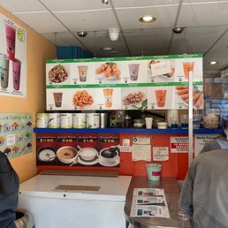 a man and a woman standing in front of a counter