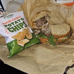 Italian steak sandwich with chips. Italian steak sandwich with chips.