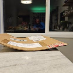 US Post Office - Says Please Do Not Bend and he rolled the large envelope to fit in diagonally so art is creased AND wet.