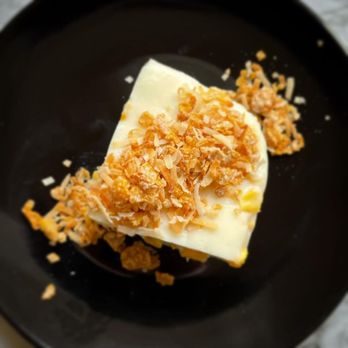 Kusina - a dessert on a black plate - Filipino Near Me Kusina - a dessert on a black plate - Filipino Near Me