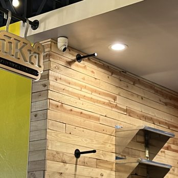 kūKri - a wooden wall with a sign above it - Chicken Shop Near Me - Albuquerque, New Mexico