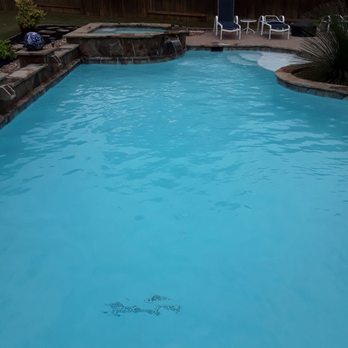 Buzzy's Pool Service - a pool with a blue water - Lawn Services Near Me Buzzy's Pool Service - a pool with a blue water - Lawn Services Near Me