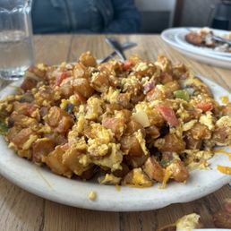 An undifferentiated mass of cold, soggy and bland potatoes with a few eggs, some cheese, and tiny pieces of tough chicken.