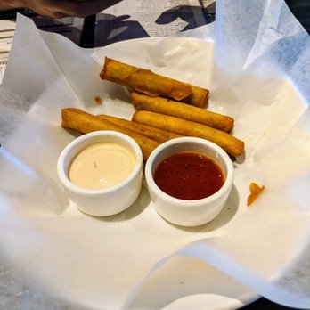 Yard House - Pork Lumpia appetizers. Very good, both sauces are very different and delicious. Comes with 6 lumpias. - Bars Near Me - Roseville, California Yard House - Pork Lumpia appetizers. Very good, both sauces are very different and delicious. Comes with 6 lumpias. - Bars Near Me - Roseville, California