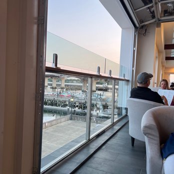 Mission Boathouse - Seating by the windows... garage style openings. Awesome - Venues & Event Spaces Near Me - Beverly, Massachusetts