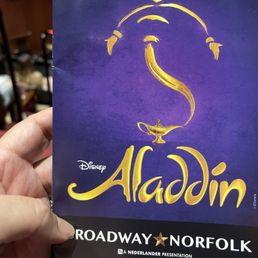 a hand holding a copy of the broadway musical a hand holding a copy of the broadway musical