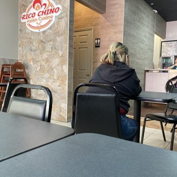 Rico Chino - a woman sitting at a table in a restaurant - Puerto Rican Near Me - Orlando, Florida