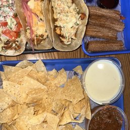 Fish taco, fried chicken taco, hot honey taco, cheese dip and salsa Fish taco, fried chicken taco, hot honey taco, cheese dip and salsa