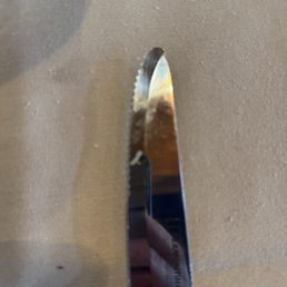 This dirty steak knife was placed under my ribeye... Gross!!! This dirty steak knife was placed under my ribeye... Gross!!!