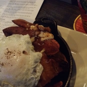 Bosscat Kitchen & Libations - Duroc pork poutine topped with duck fat fried egg. Those are not fries, but more like Potatoe boats. Oh and whiskey. - New American Near Me - Irvine, California