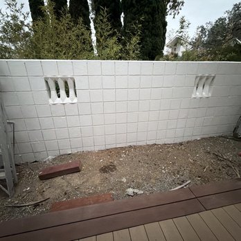 Hillside Pavers - Before of left side of courtyard - Landscaping Near Me