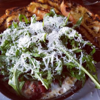 Oenotri - Fried egg skillet as you can see on the sides of the skillet cooked egg white hidden under the rocket salad - Italian Near Me - Napa, California Oenotri - Fried egg skillet as you can see on the sides of the skillet cooked egg white hidden under the rocket salad - Italian Near Me - Napa, California