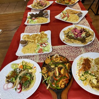 Angela Restaurant - a long table with plates of food on it - Honduran Near Me - Baltimore, Maryland Angela Restaurant - a long table with plates of food on it - Honduran Near Me - Baltimore, Maryland
