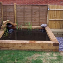 Liquid Landscapes - A rasied sleeper pond with hidden filtration and an arch and waterfall.
