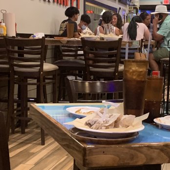 Hooters - people eating at a restaurant - Chicken Wings Near Me - Destin, Florida Hooters - people eating at a restaurant - Chicken Wings Near Me - Destin, Florida