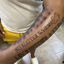 In the cut ink - American typewriter font tailored to fit with the existing tattoo by adding clouds to match the original design.