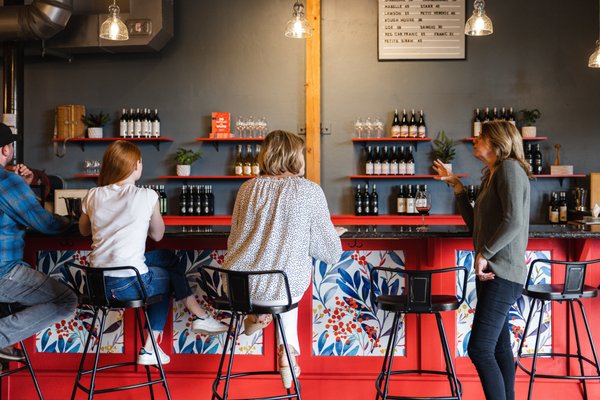 Photo of Covington Cellars - Woodinville, WA, US. a group of people sitting at a bar