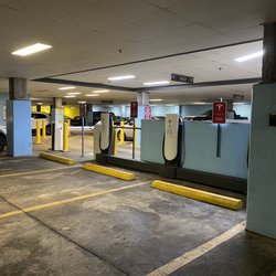 Tesla Supercharger - The area over the blue barrier is the entry ramp. You must drive forward to eventually get to the chargers.