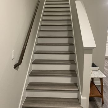 High Tech Flooring & Design - a dog sitting on the stairs - Flooring Near Me - Austin, Texas