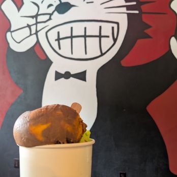Black Cat Ice Cream - Orange and chocolate ice cream in front of the black cat logo. - Ice Cream & Frozen Yogurt Near Me - Des Moines, Iowa