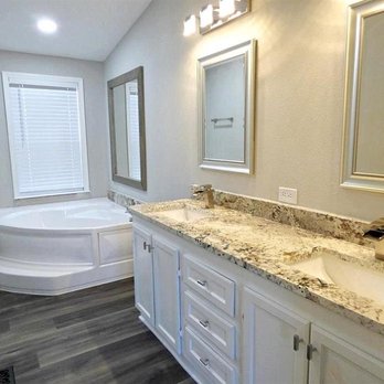 Solotzo Roofing - a bathroom with a tub and a sink - Roofing Near Me Solotzo Roofing - a bathroom with a tub and a sink - Roofing Near Me