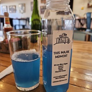 White Birch Juice - a bottle of blue liquid and a glass of water - Juice Bars & Smoothies Near Me - Abingdon, Virginia White Birch Juice - a bottle of blue liquid and a glass of water - Juice Bars & Smoothies Near Me - Abingdon, Virginia