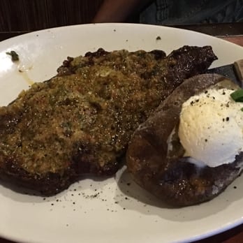 Red White & Brew - Crusted ribeye with baked potato. I am told you have to ask for the crusting-- not in the menu. Do it! Soooooo good! - American Near Me - Mesa, Arizona