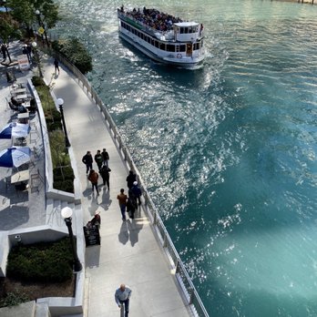 Chicago Riverwalk - A River Cruise Tour Boat passing Pedestrians on the Chicago Riverwalk - Landmarks & Historical Buildings Near Me - Chicago, Illinois Chicago Riverwalk - A River Cruise Tour Boat passing Pedestrians on the Chicago Riverwalk - Landmarks & Historical Buildings Near Me - Chicago, Illinois