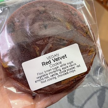Vegan Tierra - a person holding a chocolate cake - Vegan Near Me - Cooper City, Florida