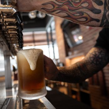 Capitol Public House - a man filling a pint of beer - Whiskey Bars Near Me - Eagle, Colorado