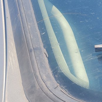 Safelite AutoGlass - Damaged the rubber gasket on my vehicle on installation - The image shows a vehicle's windshield with a damaged rubber gasket and a crack along the edge, taken from outside the vehicle. - Auto Glass Services Near Me - Albuquerque, New Mexico